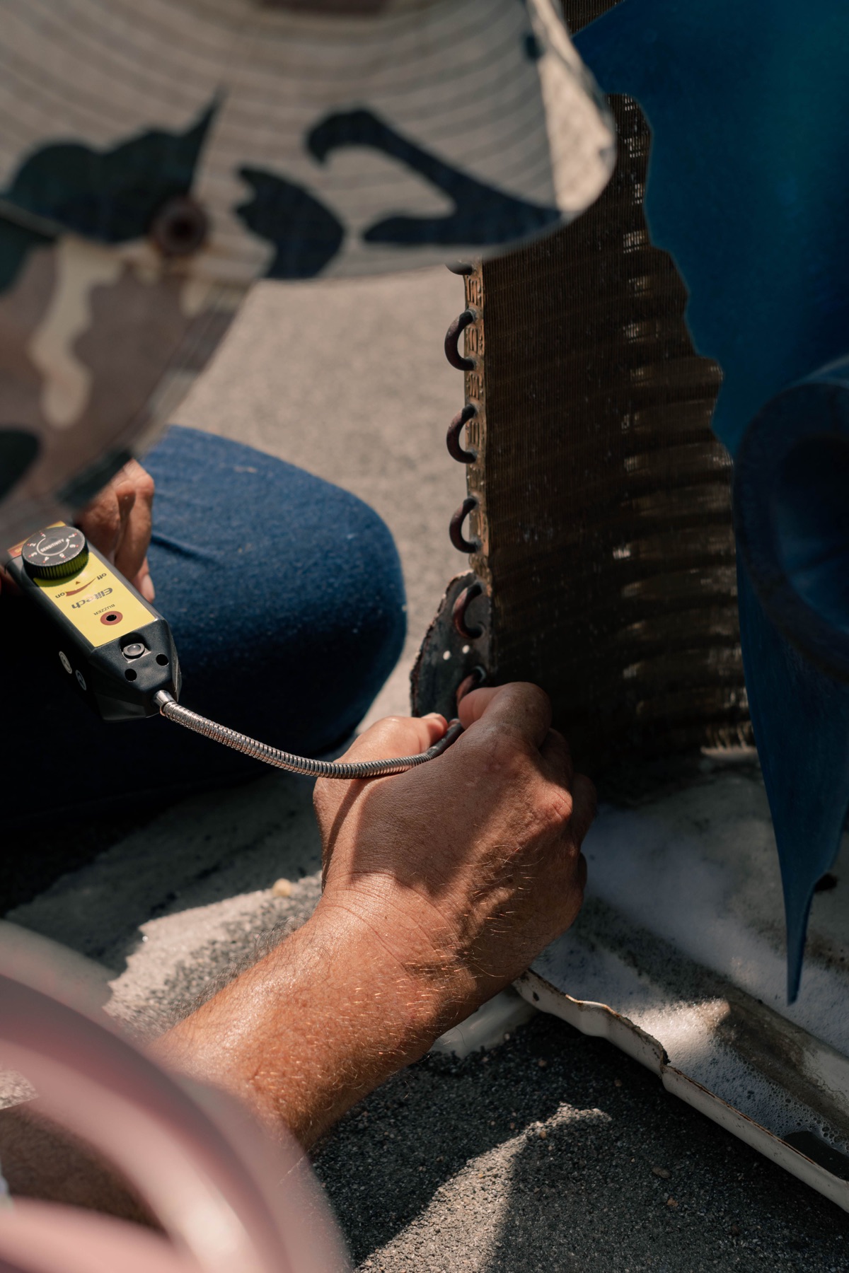 Heating and cooling technician inspecting residential equipment